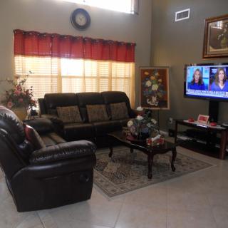 A cozy living room featuring a comfortable sofa, a television, and a decorated coffee table.