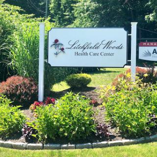Entrance sign for Landfield Woods Health Care Center, surrounded by lush landscaping.