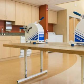 A physical therapy room equipped with exercise machines for rehabilitation.