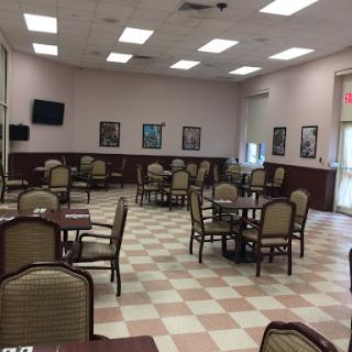 A spacious and well-lit dining area with tables and chairs, ready for guests.