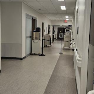 A view of a clean and well-lit hospital corridor.