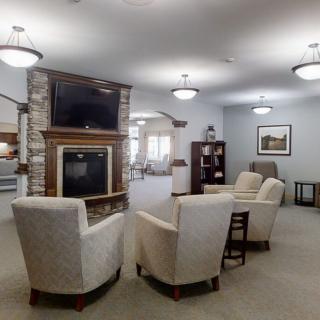 A cozy living room with comfortable seating and a fireplace under a modern dcor.