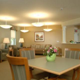 A modern living and dining area with comfortable seating and warm lighting.