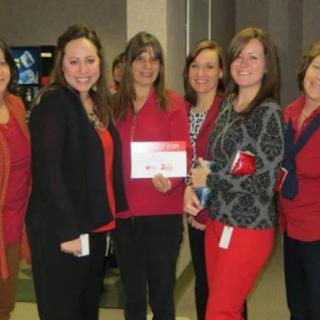 A group of women gathered together at an office event.