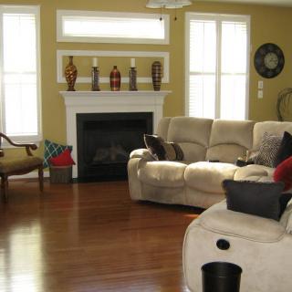 A cozy living room with a fireplace, comfortable sofas, and decorative elements.