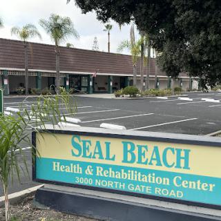 The entrance of the Seal Beach Health & Rehabilitation Center, showcasing its inviting exterior and ample parking space.