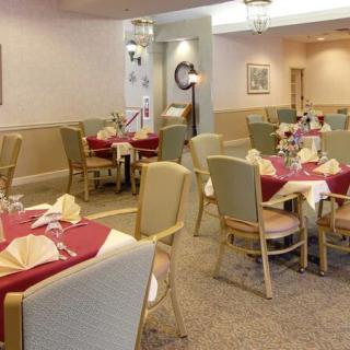 A well-arranged dining area with tables and chairs set for service.
