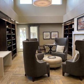 A cozy library space with modern armchairs and bookshelves.