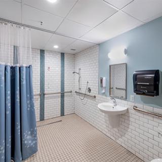 A clean, modern bathroom featuring a shower area and accessible amenities.