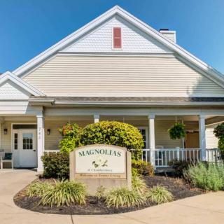 A residential building entrance with a well-maintained garden and a sign reading 'Summit Hills'.