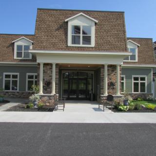 A modern residential building with a prominent entrance and traditional architectural features.