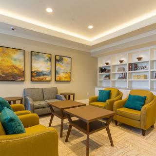 A modern, cozy living room with comfortable seating and stylish artwork.