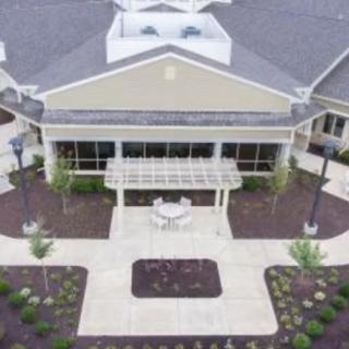 Aerial view of a building with a landscaped entrance.
