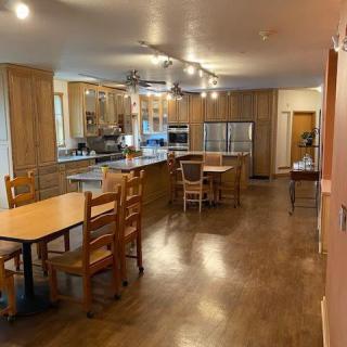 Spacious kitchen and dining area with modern wooden furnishings.
