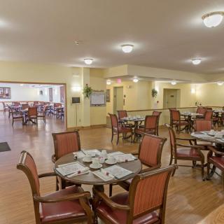 An empty dining area with multiple tables and chairs arranged neatly.