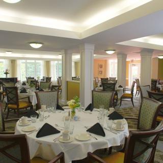 A well-decorated dining area with neatly arranged tables and chairs.