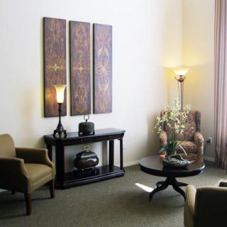 A cozy living room with elegant furniture and decorative artwork on the wall.