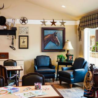 A cozy living room with comfortable seating and decorative artwork.