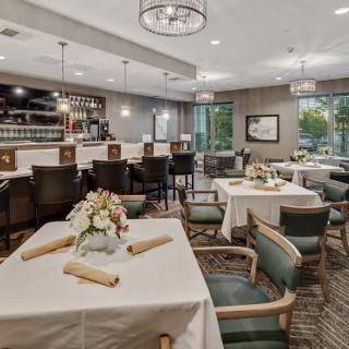 A well-decorated restaurant dining area with tables, chairs, and a bar.