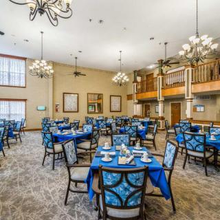 An elegant dining room with blue-themed decor and chandeliers.