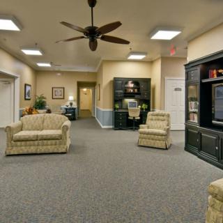 A cozy lobby area with comfortable seating and a ceiling fan.