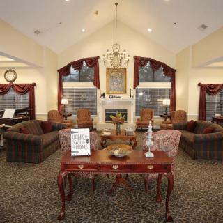 Elegant living room with comfortable seating and a central fireplace.
