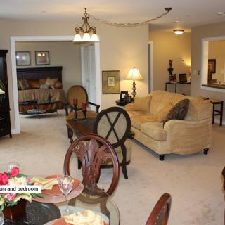 A cozy living and dining area with elegant furniture and warm lighting.