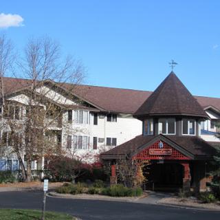 A charming residential building with a distinctive entrance under a clear blue sky.