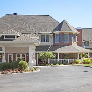 A large residential building with a landscaped front area.