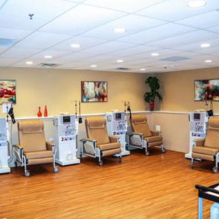 A healthcare clinic interior with medical treatment chairs lined up against the wall.