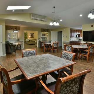A cozy dining area with wooden furniture and warm lighting.