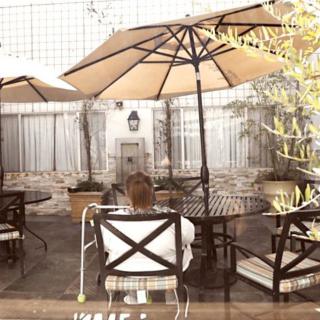 A peaceful outdoor patio area with seating and umbrellas, perfect for relaxation.