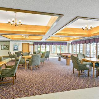 A spacious and inviting recreation room with comfortable seating arrangements and natural light.