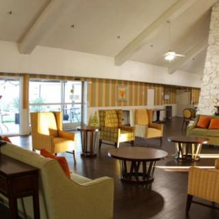 A cozy lounge area with modern furniture and warm color tones.