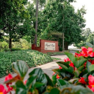 A welcoming entrance surrounded by lush greenery and vibrant flowers.