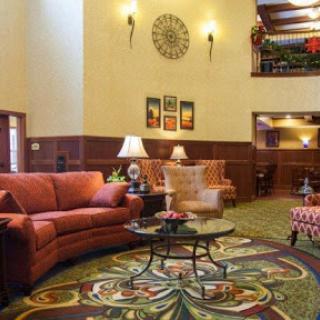 A cozy and inviting lobby area featuring comfortable seating and decorative elements.