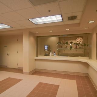 A hospital reception area with a counter and waiting space.