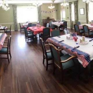 A dining room with tables and chairs decorated in a patriotic theme.