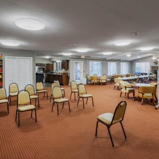 An empty conference room with chairs arranged in a semi-circle.