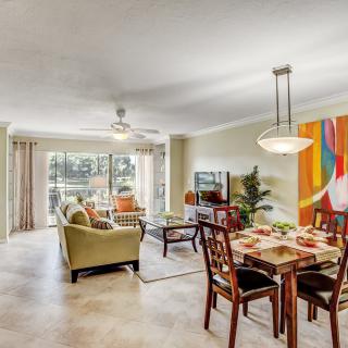 A modern open-plan living and dining area with stylish furnishings and vibrant artwork.