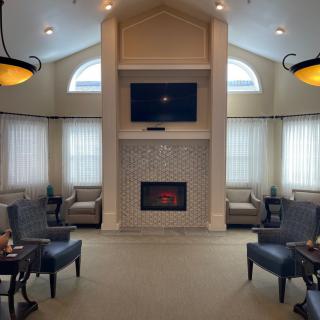 A cozy living room with a fireplace, television, and comfortable seating.