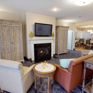 A cozy living room featuring a fireplace, TV, and comfortable seating arrangement.