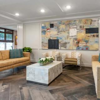 A modern living room with stylish furniture and abstract artwork.