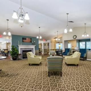 A spacious and well-lit lobby area with comfortable seating and a fireplace.