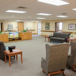 A spacious waiting room with comfortable seating and a reception desk.