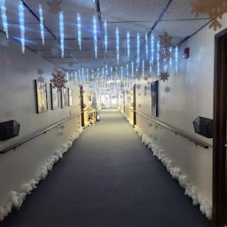 A beautifully decorated winter-themed hallway with blue lights and snowflake ornaments.