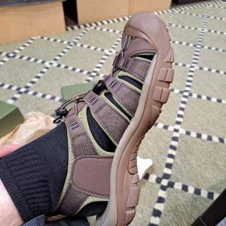 A comfortable outdoor sandal paired with a black sock.