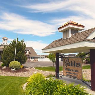 Entrance to a retirement community with well-maintained landscaping and clear signage.