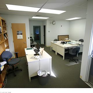 A typical office setting with desks, chairs, and computers.