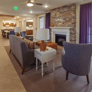 A modern living room with a cozy fireplace and stylish furniture.